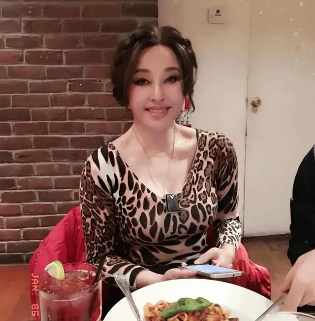 刘晓庆在国外与小鲜肉共进晚餐，穿低胸豹纹服好性感，不愧是庆奶